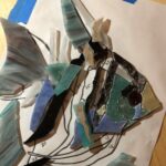 cut glass of the angel fish being placed onto the sketch below