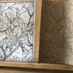 A detailed line sketch with numbers in each shape has been duplicated onto brown butcher paper with carbon paper