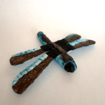 Dragonfly sculpted with plaster gauze and painted black, brown and metallic blue