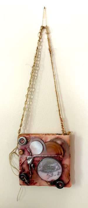 a square mixed media painting of cream, gold, silver, and burgundy that has various circular found objects layered over top of each other, two are mirrors, smaller ones along the edge have holes through the center and some are strung onto the split wire arm of a figure appearing to be turned away from the other arm which is as long as the entire height of the figure and outstretched at a very straight right angle reaching between the two mirrors and appearing to point with its spring-like twisted hand and pointer finger to the underside of a clearly visible golden disc at the top of a heap of less distinguishable discs