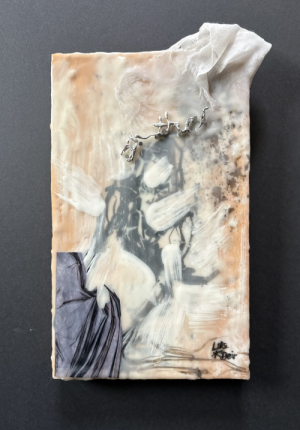 a figural, recoiling silhouette being pulled toward the bottom corner by a linear black and gray mass and by the head toward the top right corner by a mass of white fabric with gold leaf raining down; the head has the soldered wire words "In The..." nailed to it and protruding out and up; the body appears to have been shaped by taking blows or punches from white brush strokes that look to have come at it like comets flying through the air